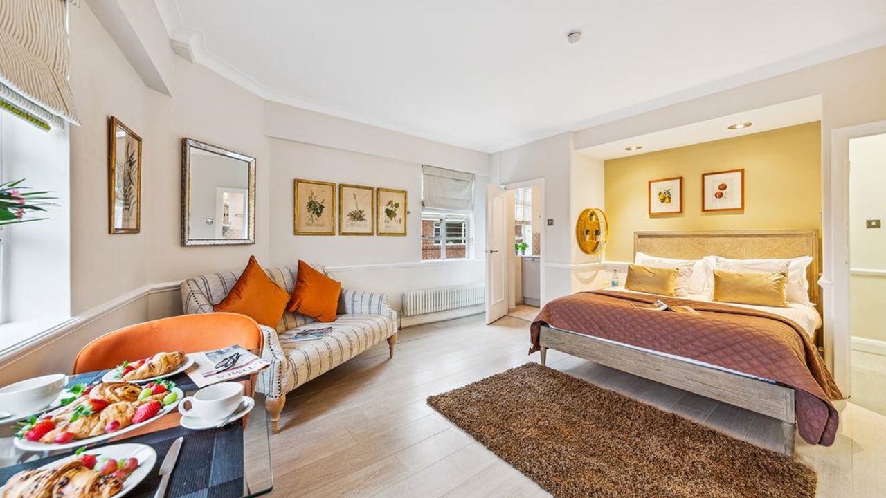 Art Deco living area with orange accents in Nell Gwynn House apartment 746