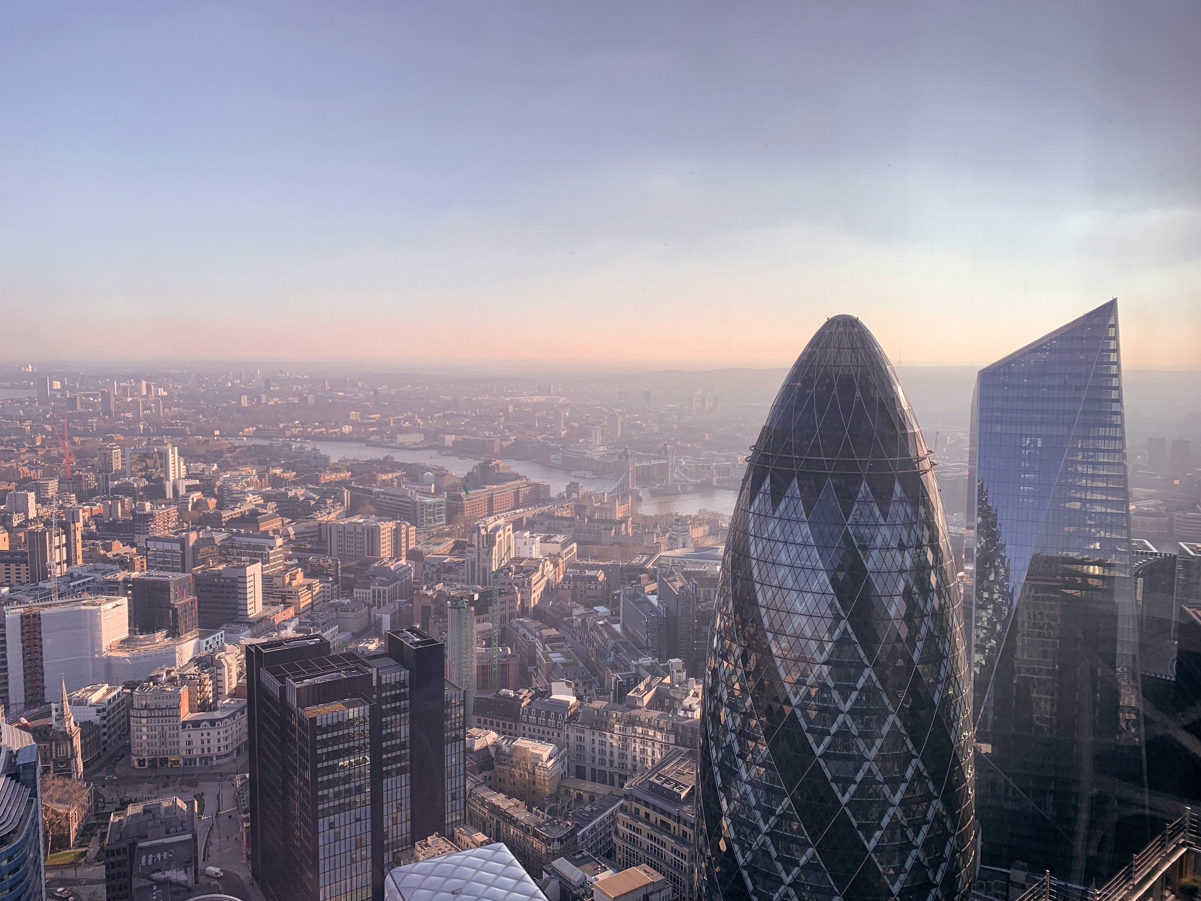 London skyline showing The Gherkin and surrounding City of London buildings at dusk