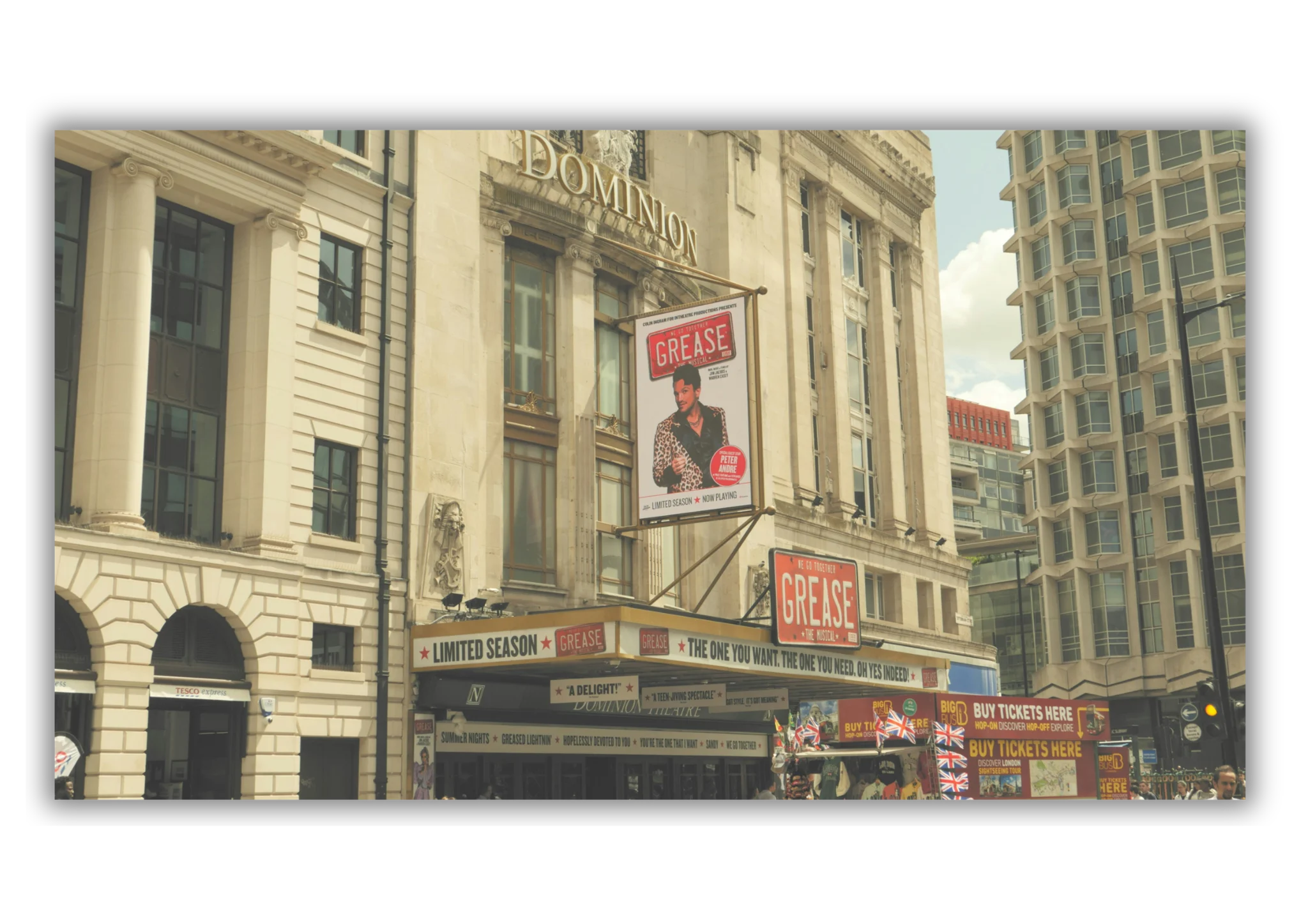 Bright theatre lights and signage on a West End street at night