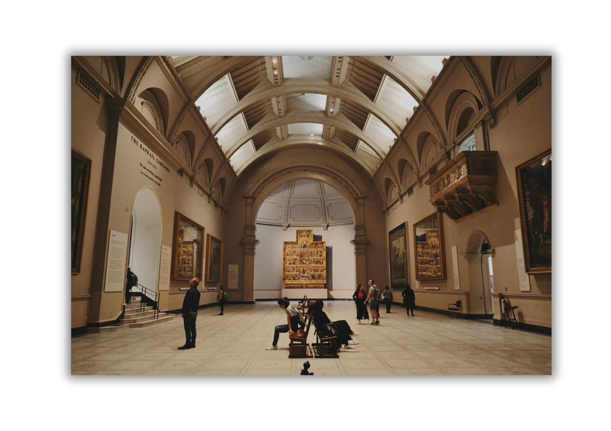Grand arched gallery interior with visitors viewing art collections